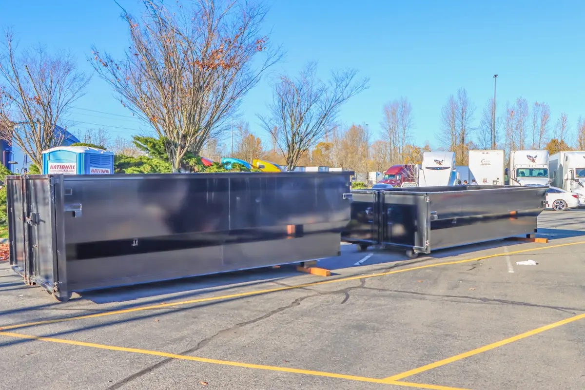 Professional dumpster rental service with roll-off container on residential driveway in Kansas City